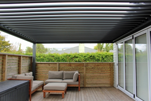 Wall mounted louvre roof finished in grey friars for protection on this well used family deck
